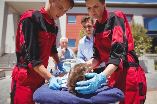 doctors putting person in ambulance