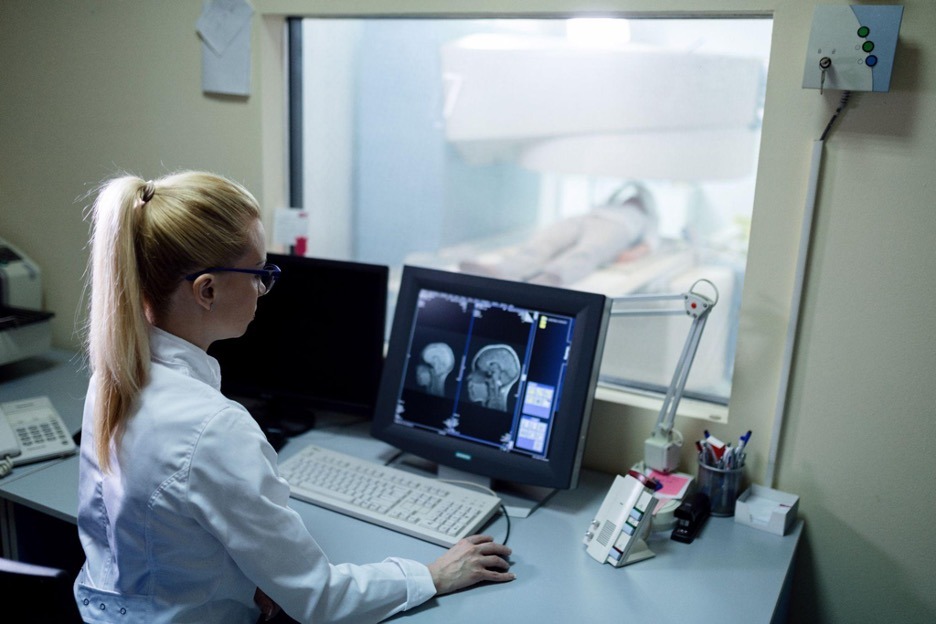 female doctor looking at brain scan