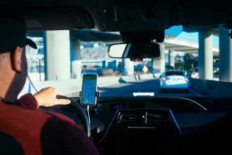 Rideshare driver using GPS navigation in a car