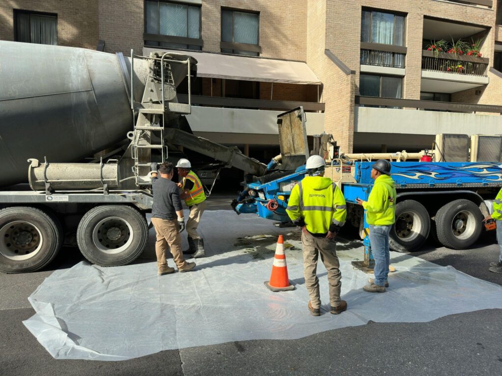 construction workers working with a concrete truck