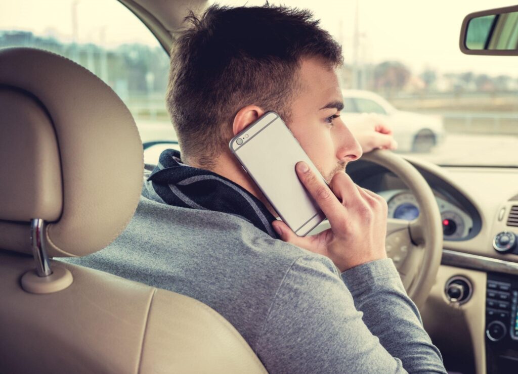 a man calling using his phone while driving