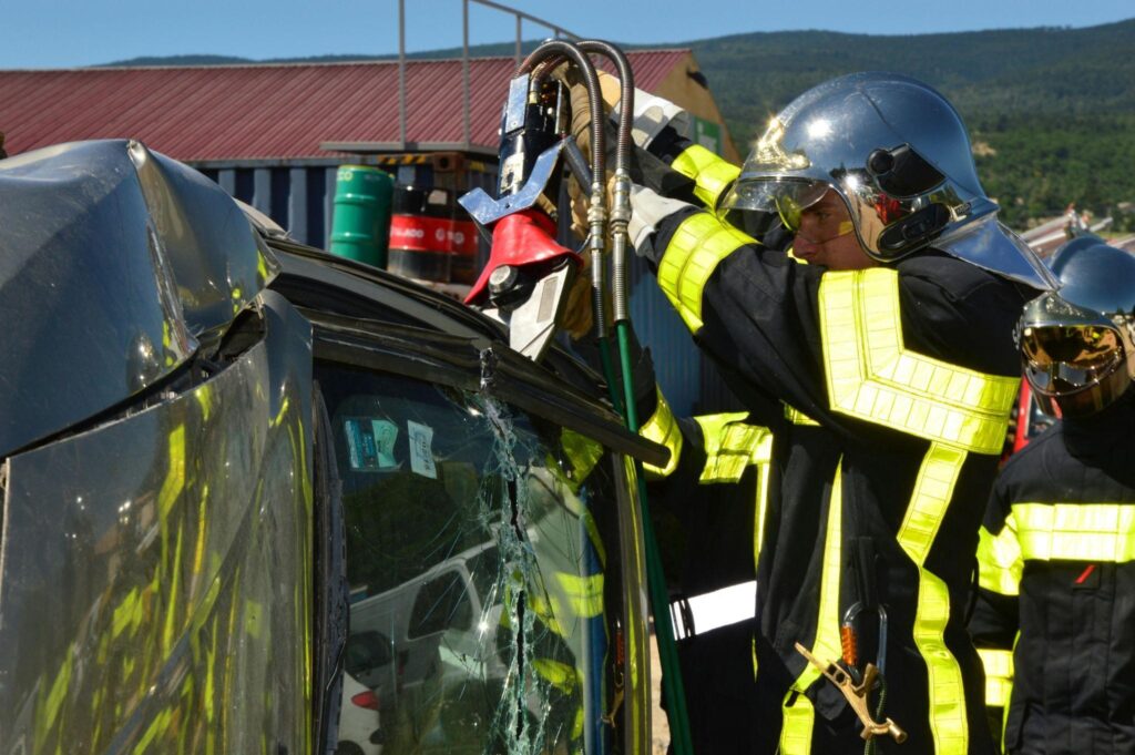 a fire fighter cutting the walls of the wrecked car