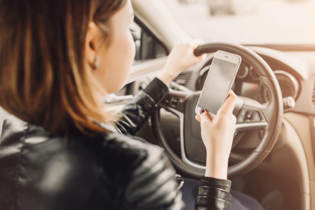 a lady texting while driving