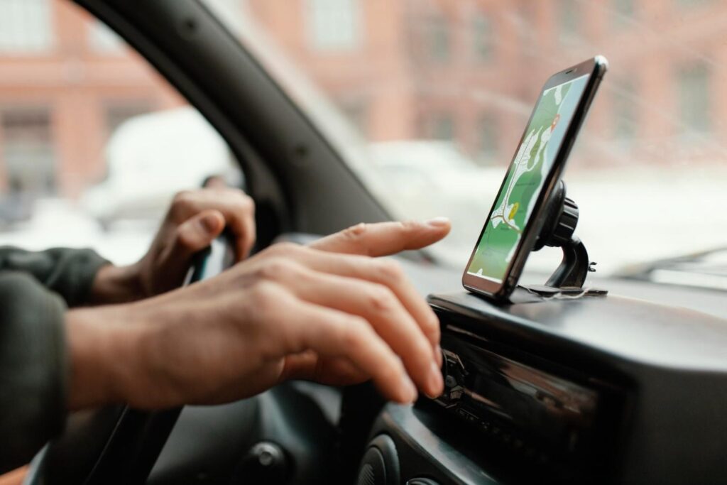 person driving while using a map in the phone