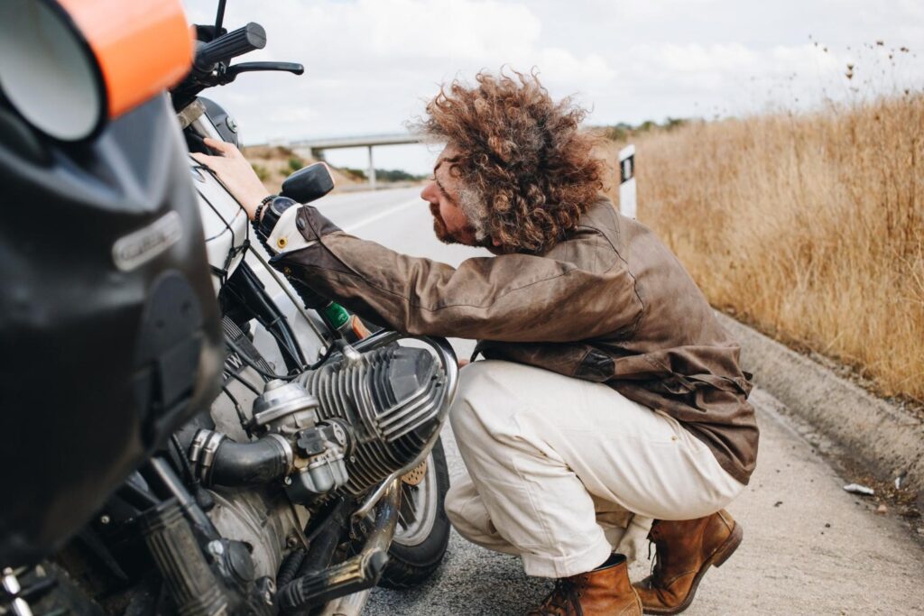 a man checking his motorcycle