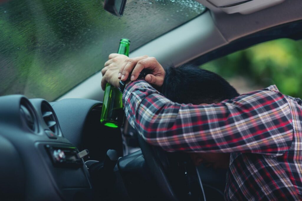 a man drinking while driving