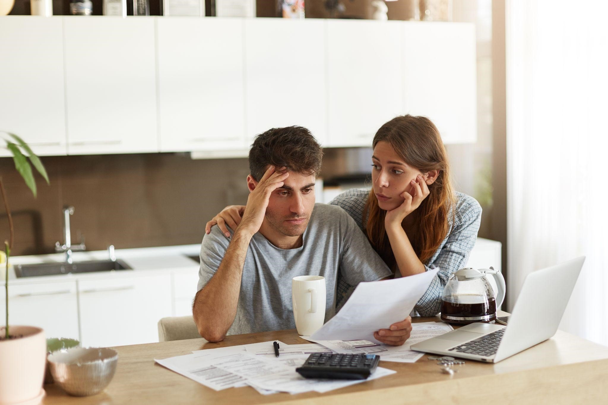 two people worrying while reading a paper