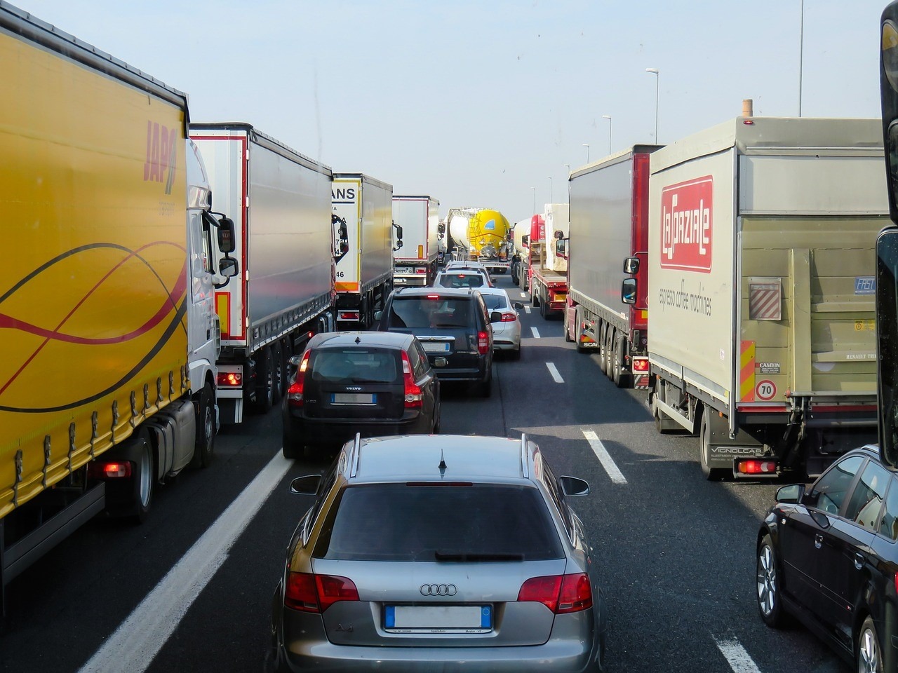 cars driving in the middle of the trucks