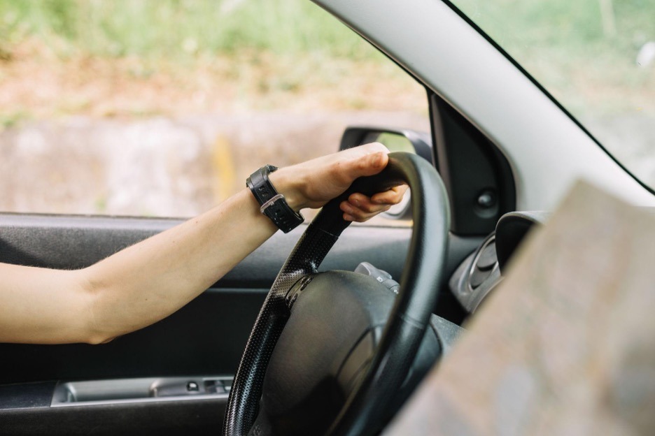 person with hand on wheel
